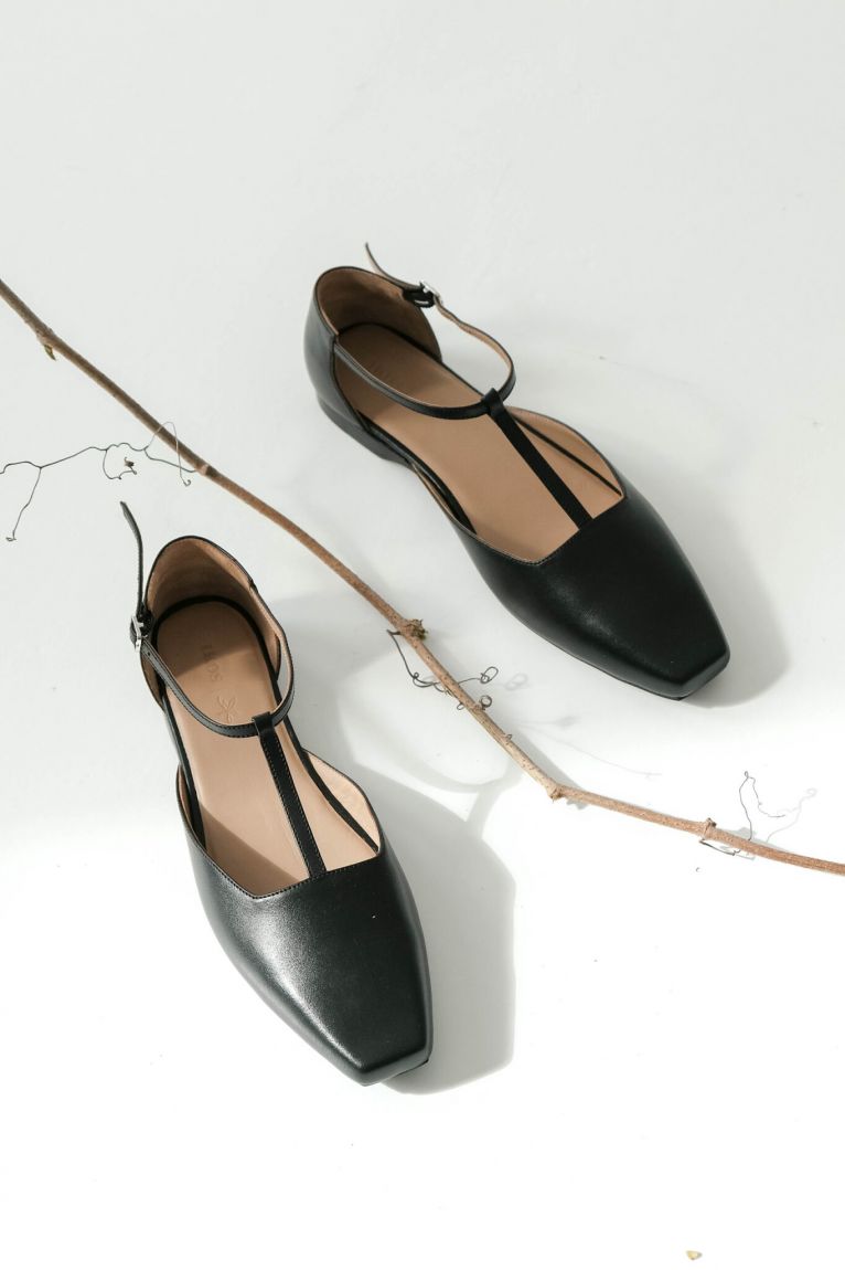 Black T-bar shoes with an elongated toe