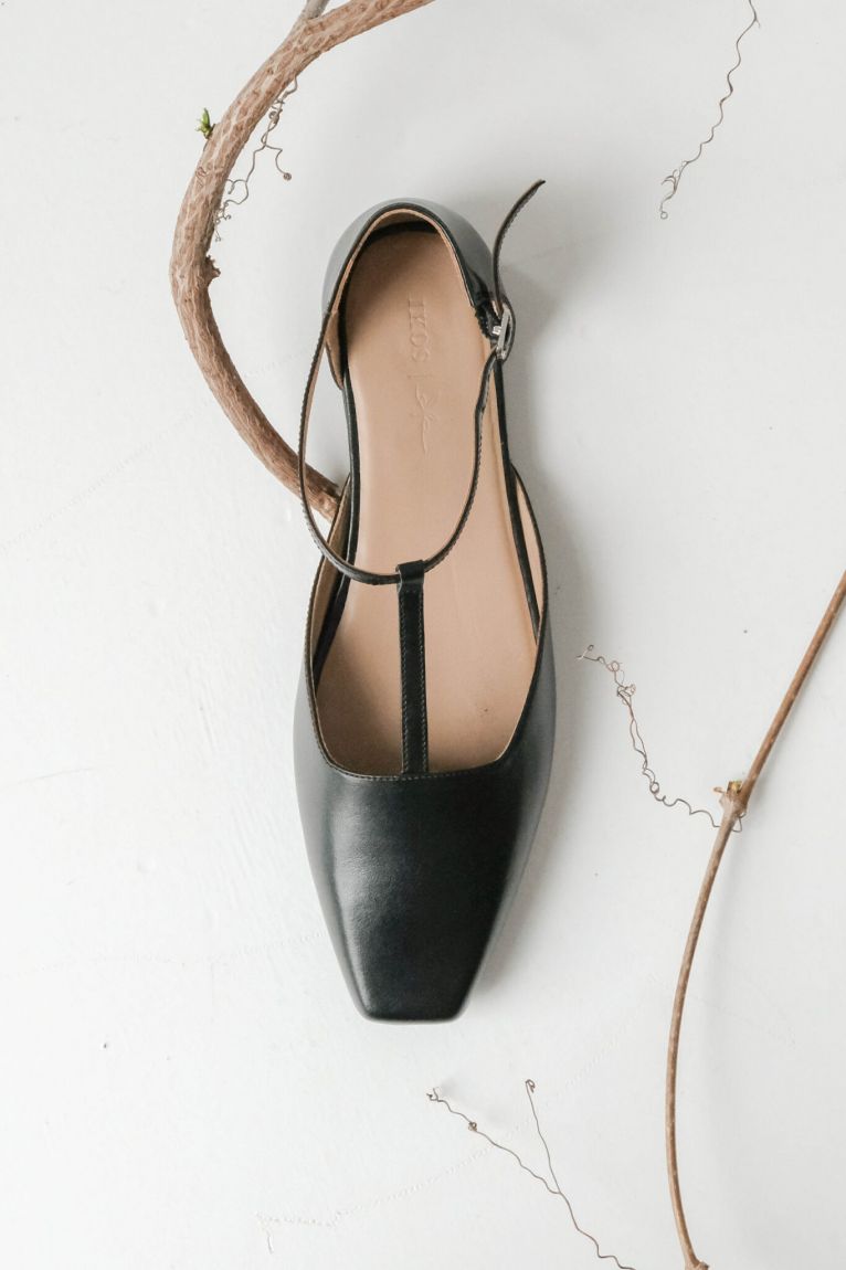 Black T-bar shoes with an elongated toe