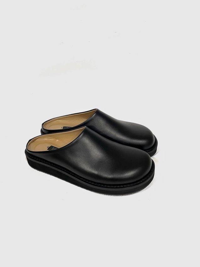 Black leather mules on a flat sole